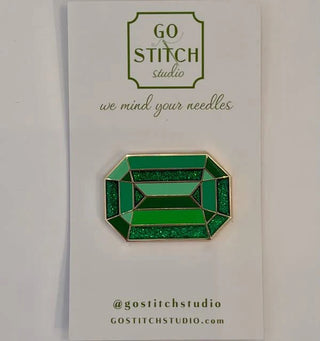 Green diamond needle minder with gold border